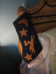 A Christmas stocking hangs on a bed in Vermont.