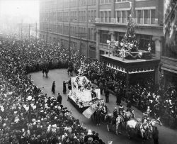 Eaton's Santa Claus Parade, 1918, Toronto, Canada.  Having arrived at the Eaton's department store, Santa is readying his ladder to climb up onto the building.