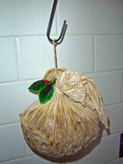 Christmas puddings are often dried out on hooks for weeks prior to serving in order to enhance the flavour. This pudding has been prepared with a traditional cloth rather than a basin.