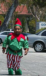 Tony Cox as Marcus in the movie Bad Santa, who is working as an elf assisting Santa Claus at a supermarket.